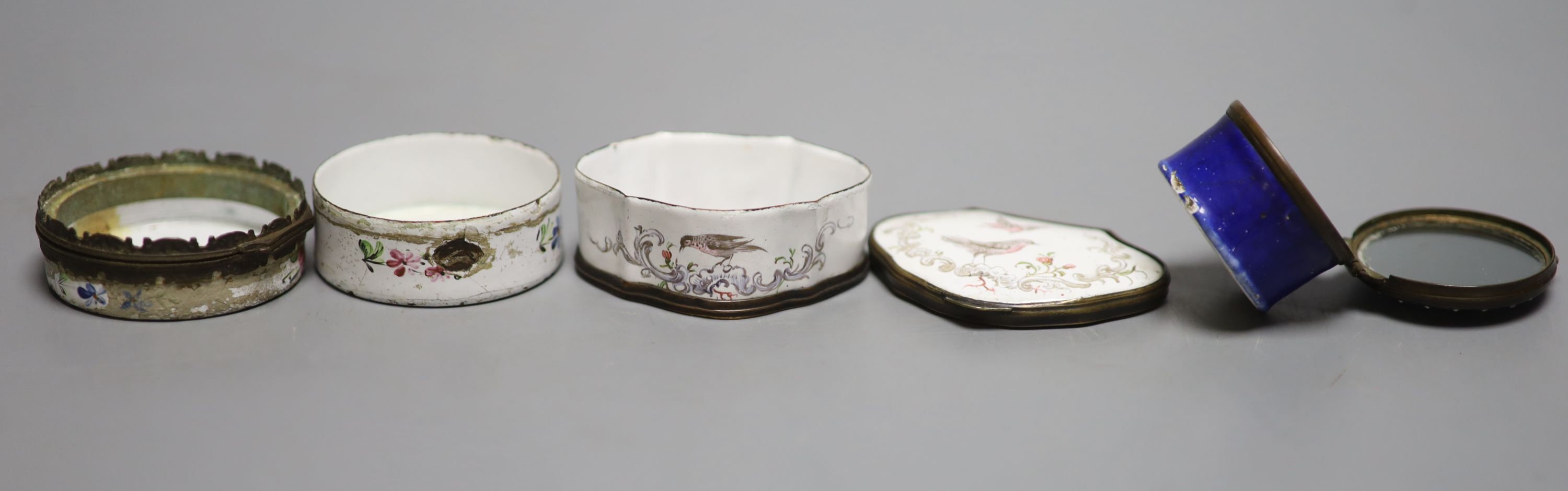 An 18th century white enamelled box painted with a palace, 5cm., a cartouche shaped box decorated with a birds, 6cm. and a patch box de